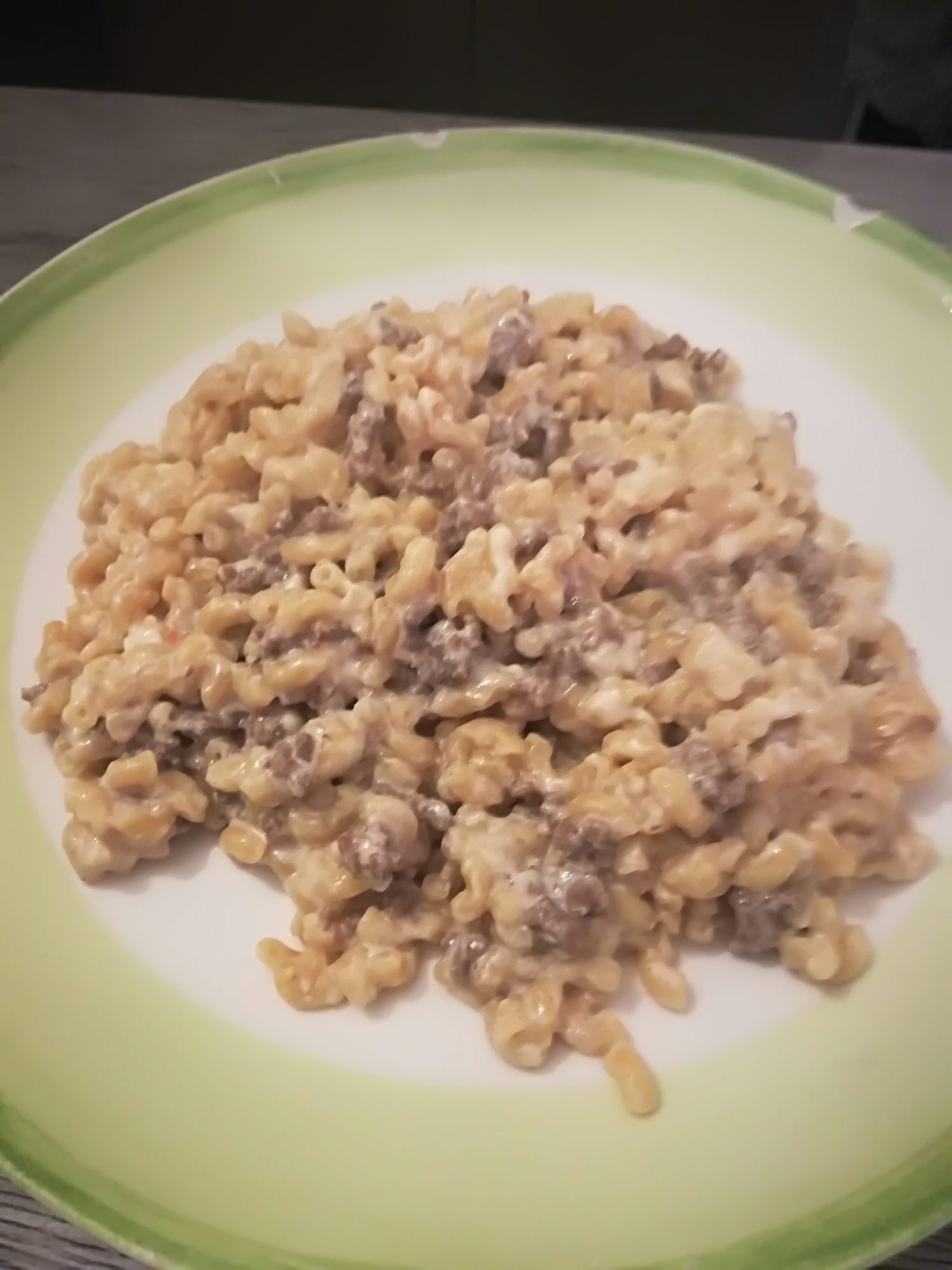 Pasta, steak of ground meat and soft cheese