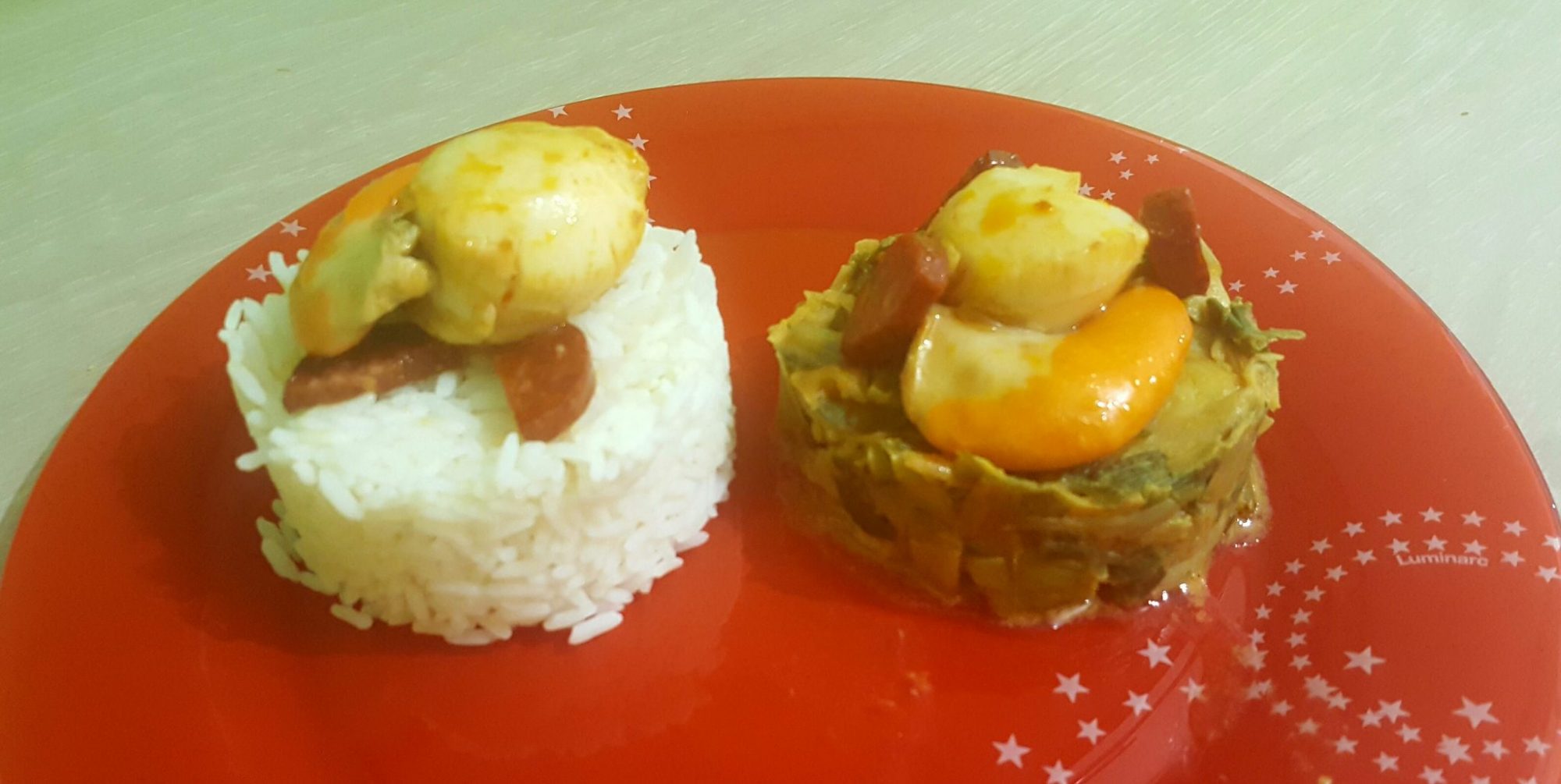 Scallops and sausage with leek and rice side by side