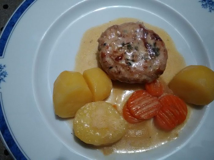 Flat white wine sausage in a pork fat caul and potatoes